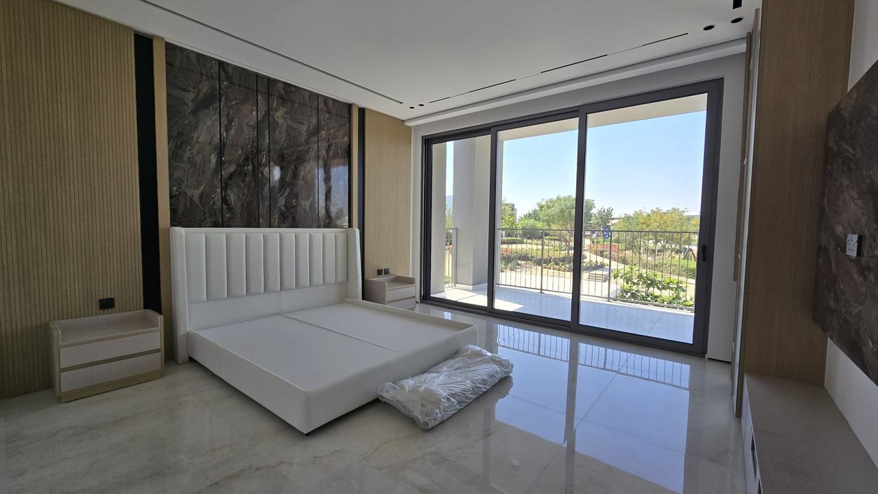 Dubai Hills villa bedroom as filmed on a phone, mattress still wrapped, verticals leaning